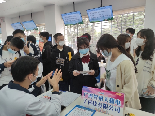 图为招聘会现场求职者正在与企业人事交谈